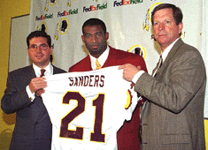 [Deion "Poo-head" Sanders and a couple white guys, the three of whom combined earn more than your entire town COMBINED]